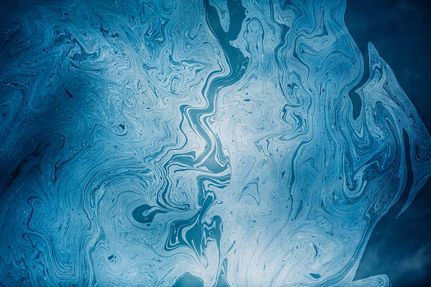 Abstract Oil Pattern On The Water Blue oil slick on water surface. Water pollution pool leak stock pictures, royalty-free photos & images