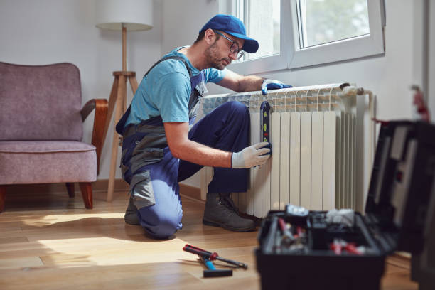 Central heating mechanic and handyman fixing home radiator, gas crisis and seasonal issues. Central heating mechanic and handyman fixing home radiator, gas crisis and seasonal issues. plumber stock pictures, royalty-free photos & images