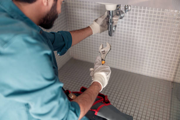 Close up of plumber is repairing faucet of a sink at bathroom using adjustable wrench Handyman is repairing faucet of a sink at bathroom. Maintenance and household assistance concept plumbing company stock pictures, royalty-free photos & images