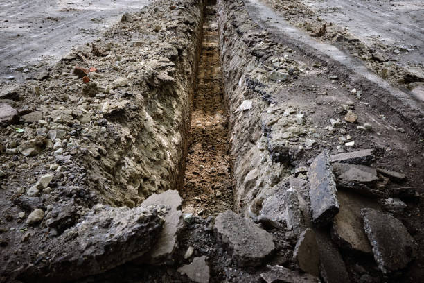 Excavated trench on the road in the city for the reconstruction of the water supply. Excavated trench on the road in the city for the reconstruction of the water supply. The work of utilities to improve the infrastructure. Sewer Line Problems stock pictures, royalty-free photos & images