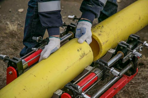 Free A Person Holding Yellow Pipes Stock Photo
