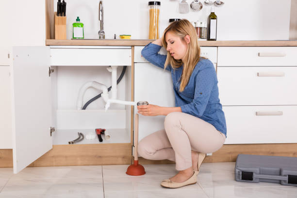 Frustrated Woman Having Kitchen Sink Problem Young Frustrated Woman Having Sink Problem Trying To Fix Sewer Drainage In Kitchen plumbing issues stock pictures, royalty-free photos & images