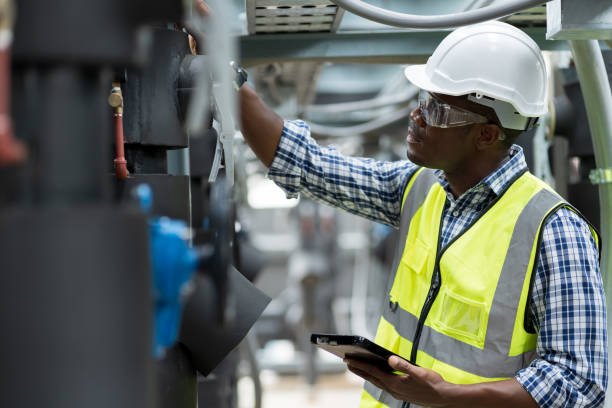 Male plumber engineer working at sewer pipes area at construction site. African American male engineer worker check or maintenance sewer pipe network system at construction sit Male plumber engineer working at sewer pipes area at construction site. African American male engineer worker check or maintenance sewer pipe network system at construction sit plumbing stock pictures, royalty-free photos & images