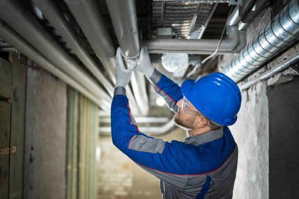 Male Worker Inspecting Pipes Male Worker Inspecting Water Pipes For Leaks In Basement plumbing stock pictures, royalty-free photos & images