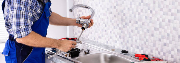 Plumber Assembling The Kitchen Sink Faucet Mid Section Of Male Plumber Assembling The Kitchen Sink Faucet plumber stock pictures, royalty-free photos & images