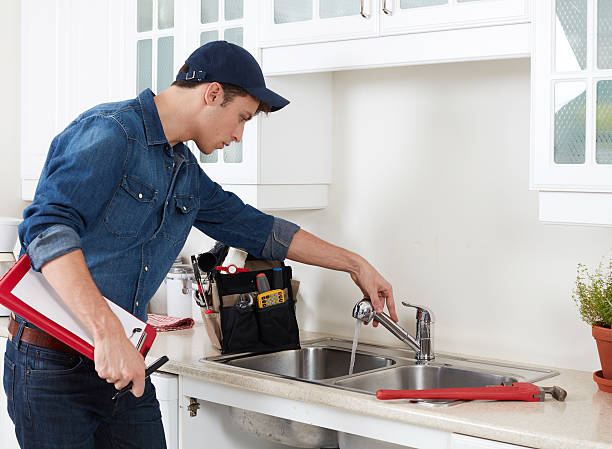 Plumber. Professional plumber doing reparation in kitchen home. plumbing services stock pictures, royalty-free photos & images