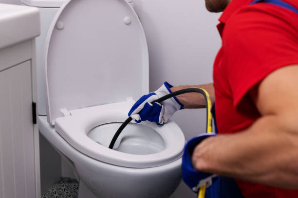 plumber unclogging blocked toilet with hydro jetting at home bathroom. sewer cleaning service plumber unclogging blocked toilet with hydro jetting at home bathroom. sewer cleaning service drain cleaning stock pictures, royalty-free photos & images