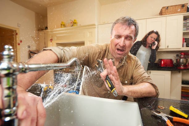 plumbing mishap give it a go DIY hero tries his hand at fixing the tap . His wife is already on the phone to an emergency plumber as water gushes from the broken tap plumbing stock pictures, royalty-free photos & images