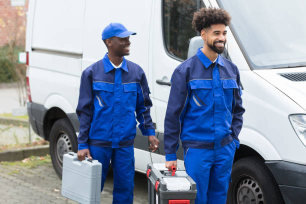 Portrait Of Two Young Manual Worker With Their Tool Boxes Portrait Of Two Smiling Manual Workers With Their Tool Boxes Standing Near The White Van plumbing team stock pictures, royalty-free photos & images