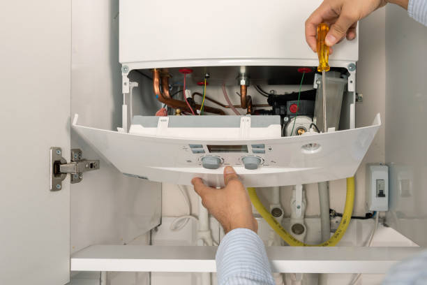 Technician repairing combi Gas Boiler Technician repairing combi Gas Boiler plumbing services stock pictures, royalty-free photos & images