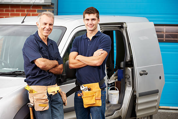 Workers In Family Business Standing Next To Van Workers In Family Business Standing Next To Van Smiling At Camera plumbing company stock pictures, royalty-free photos & images